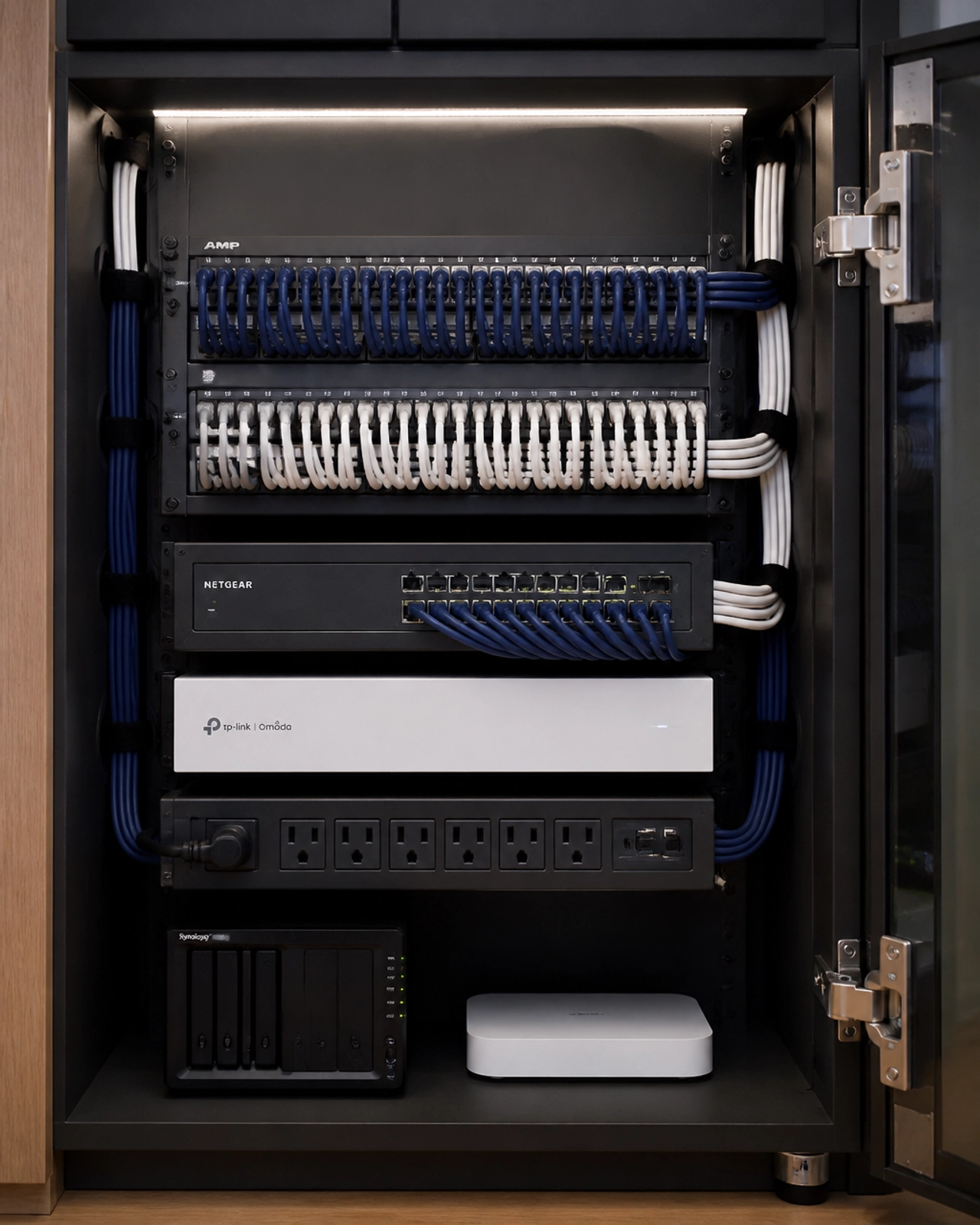 An organized, clean, and professional network hub inside an office cabinet.