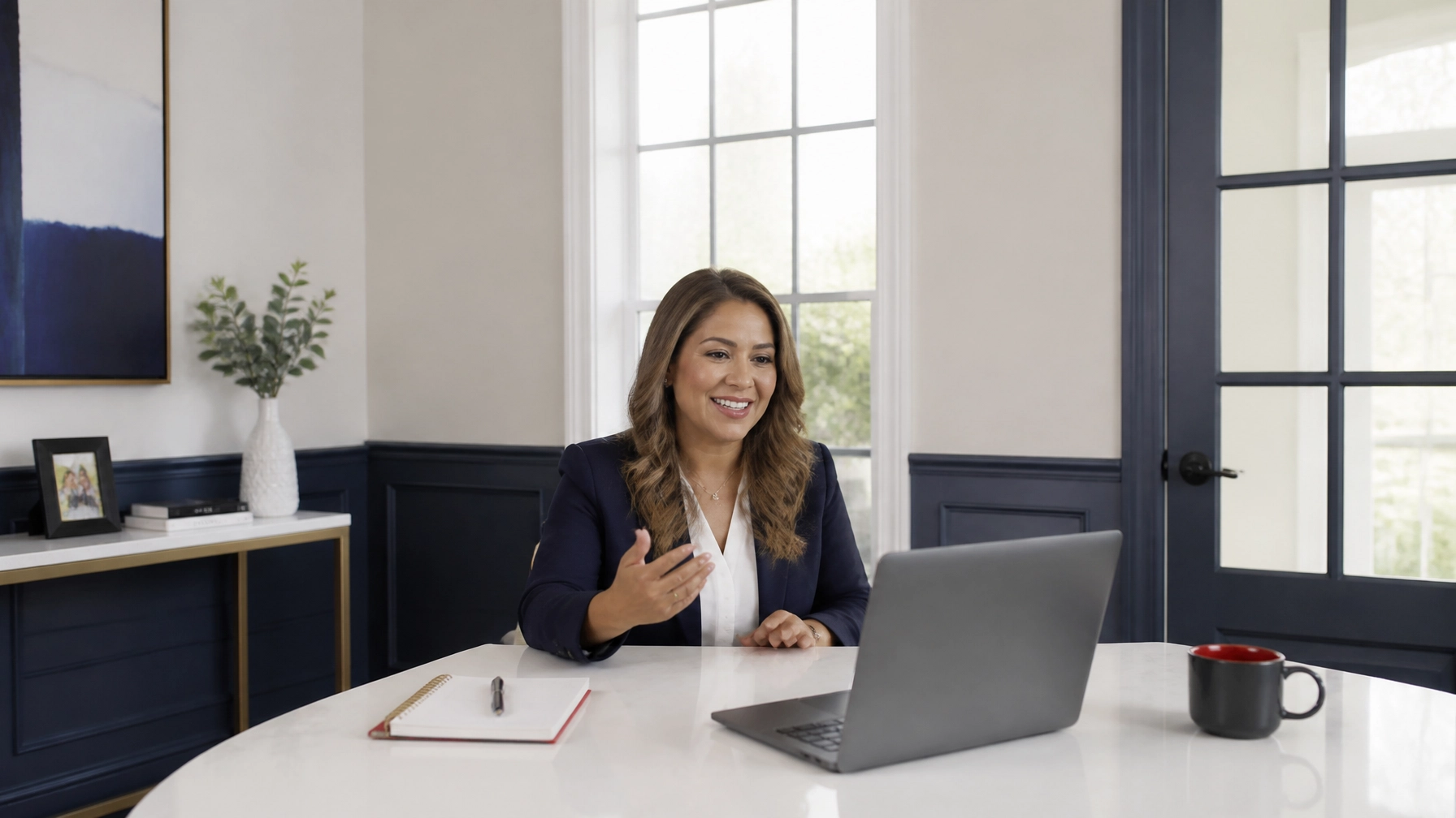 Female insurance agent of Hispanic descent with light brown hair in a bright, airy conference nook during a smooth video call, showing how stable managed internet supports clear communication without distractions.