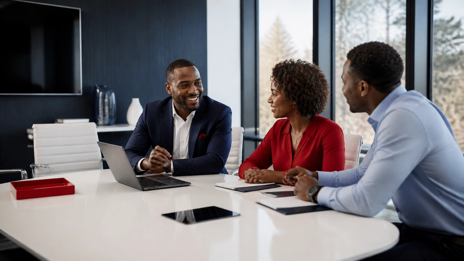 High-end insurance agency conference room with an African American male agent collaborating in a bright, airy setting with clean, seamless technology.